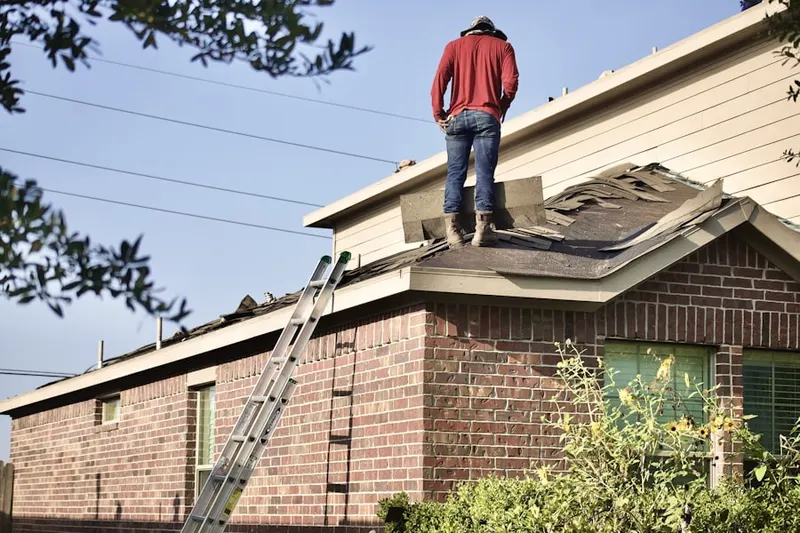 Professional roofer working on a residential roof in South Farmingdale